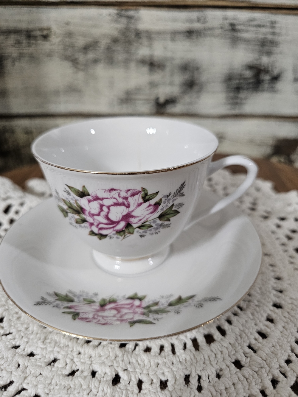 White Porcelain Tea Cup and Saucer with Pink Floral Design and Gold Trim